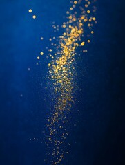 Fototapeta premium Golden Glitter on a Blue Background.
