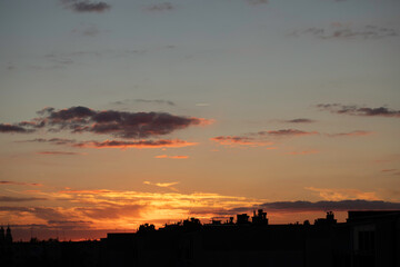 Sunrise sky above a city. Incredible natural colors. Red, orange, blue. Heaven.