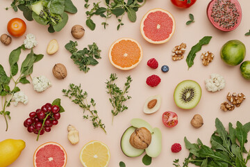 Fresh fruits and herbs arranged beautifully on light background, showcasing vibrant assortment of colors and textures. This delightful spread includes citrus, berries, and nuts, evoking sense of healt