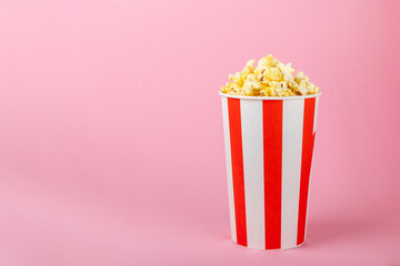 Salty popcorn on bright color background. Cinema and entertainment concept. Movie night with popcorn. Delicious appetizer, snack.Space for text, copy space. Banner