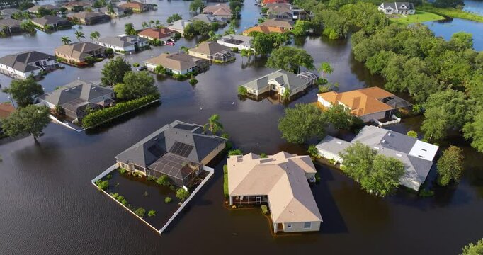 Flooding in Florida caused by tropical storm from hurricane rainfall. Suburb houses in residential community surrounded by flood waters. Aftermath of natural disaster.