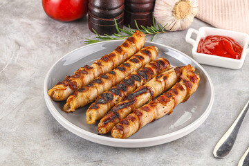 Grilled meat sausages wrapped bacon