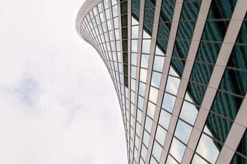 Angled view of modern skyscrapers in business district against blue sky. Looking Up high-rise...