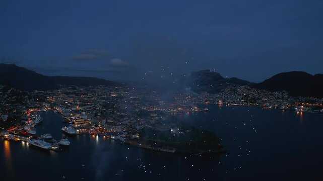 Close-up aerial shot of fireworks over Bergen, Norway on the constitution day May 17