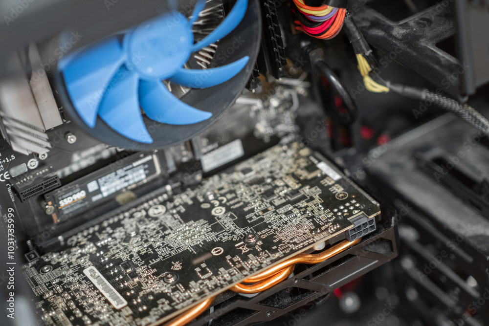 Poster a close-up view of a computer's internal components highlighting the graphics card and cooling syste