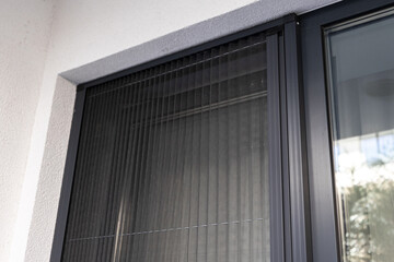 Window insect blinds. Close up photo with a plisse net type of window blinds that protect the house of insects and flies. House construction objects.