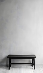 10. A simple black table against a light gray wall