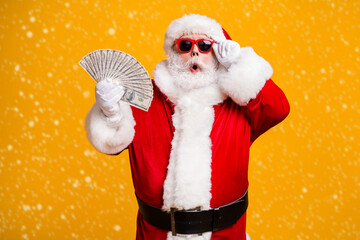 Portrait of his he nice attractive amazed astonished fat overweight bearded Santa holding in hand...