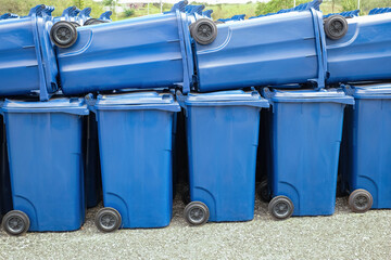 rows of new municipal colored trash cans with wheels, ready to be distributed to the population