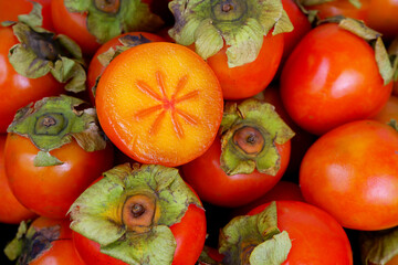Ripe orange persimmon fruits as background.