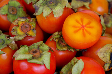 Ripe orange persimmon fruits close up.	