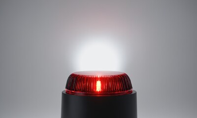 Red flashing light atop black base Studio shot