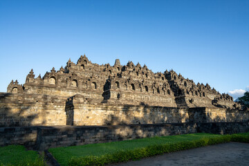 Borobudur, Mahayana Buddhist Temple in Indonesia - Mageland, Yogyakarta. Wide Angle of ancient stupa pyramid from north-west corner.