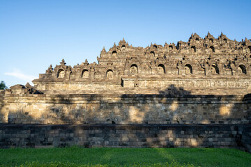 Borobudur, Mahayana Buddhist Temple in Indonesia - Mageland, Yogyakarta. Wide Angle of ancient stupa pyramid from north-west corner.