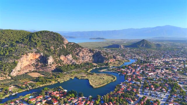 Dalyan is a town on the Dalyan River, just inland from Turkey's southwest coast. Across the river from town is the ancient ruined city of Kaunos, with Lycian rock tombs and the remains of a theater.