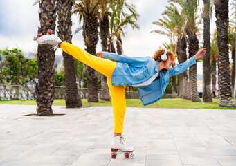 Beautiful red haired young woman with rollerskates having fun outdoors