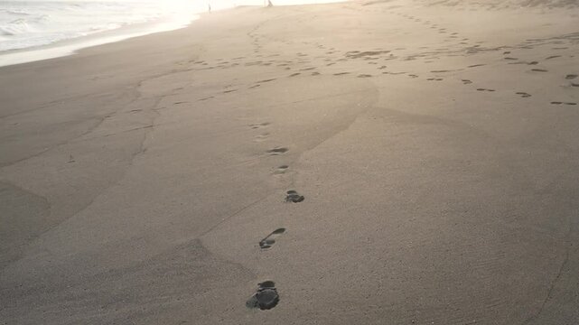footprints on the beach. footprints in the sand. along the beach sand