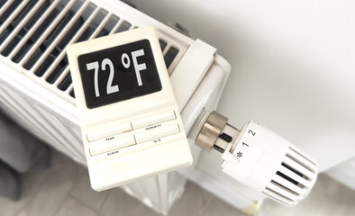 White heating battery and electronic, smart temperature regulator. warmth in the room and the house. preparation for spring and winter. energy saving