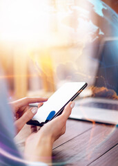 Close-up photo of female hands with smartphone. Concept of networking or remote work. Global business network.
