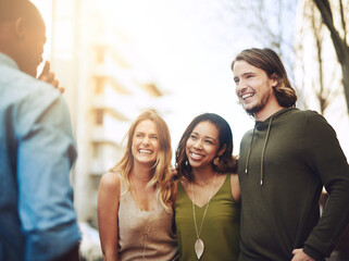 Talking, smile and friends in city together for community, bonding or tourism for weekend break. Chat, outdoor and group of happy people in urban town or street for adventure, holiday or vacation