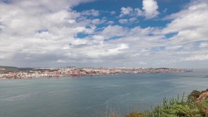 Panorama showing Lisbon cityscape and Tagus river timelapse with 25 of April bridge