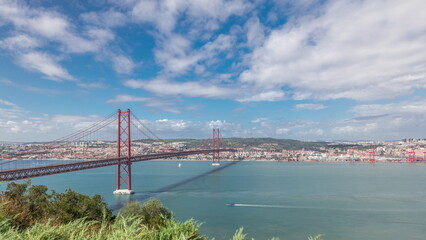 Fototapeta premium Panorama showing Lisbon cityscape and Tagus river timelapse with 25 of April bridge