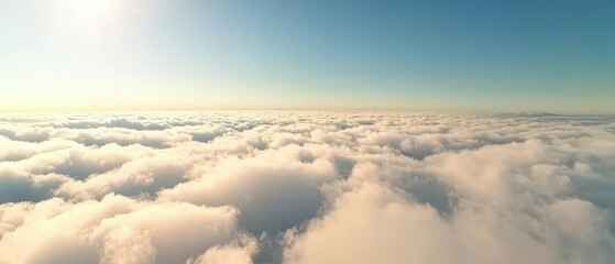 Fototapeta premium A serene view of a cloudy sky, showcasing soft clouds illuminated by sunlight against a clear blue backdrop.