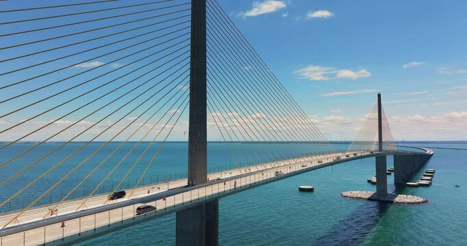 Highway road with driving traffic cars on Sunshine Skyway Bridge over Tampa Bay in Florida. Transportation infrastructure in USA