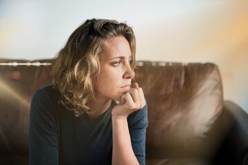 Stress woman sitting thoughtfully alone