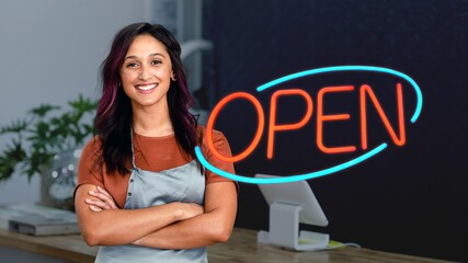 Smiling female small business owner at a cash register