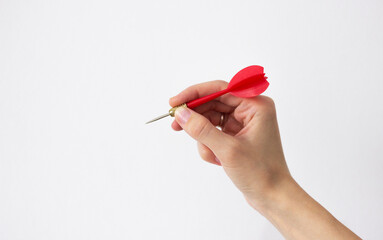 human hand holding a red dart isolated on white background