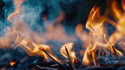 A detailed shot of burning incense, with the flames and smoke curling into the air.