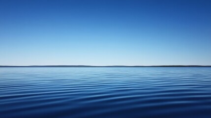 Obraz premium Serene Lake Landscape with Clear Blue Sky and Calm Water