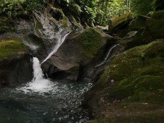 small waterfall and blue pond above Bassin Bleu in Gourbeyre, Guadeloupe, in tropical jungle