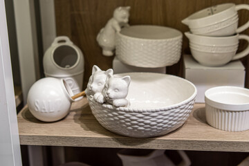 Tableware in the store. Sale of plates and mugs for home