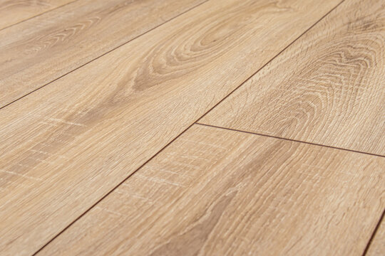 Wooden natural laminate or parquet on floor. Joining the laminate. Wood texture. Soft focus