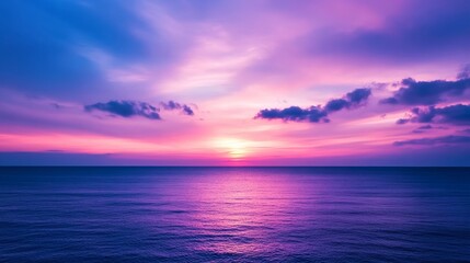 Obraz premium A glowing sunset sky painted in shades of purple and burgundy, with soft clouds reflecting the rich colors, creating a romantic and moody atmosphere 