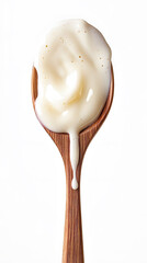 Creamy white substance cascading from a wooden spoon, evoking a sense of rich texture and indulgence in a culinary setting.