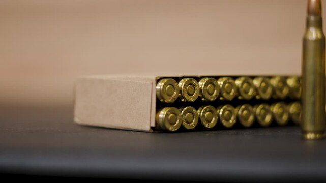 Extreme close up and slow motion of fresh boxed ammo.