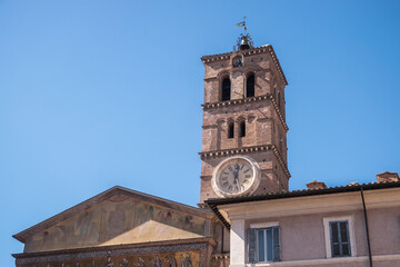 Clock and bell tower of  Basilica of Santa Maria in Trastevere district, Rome, Italy