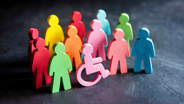 diversity and inclusion concept with wooden people figures of different color including wheelchair user