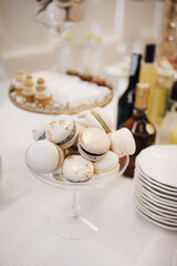 Sweet cakes in a glass bowl on a buffet table.
