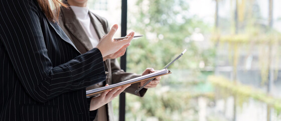 Consultants Engaged in Strategy Discussion with Pad and Pen