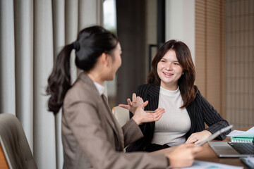 Professional Dialogue Between Businesswoman and Consultant in Office Setting