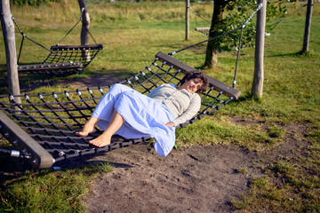 young plus size woman resting on a hammock swing