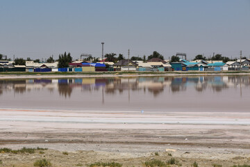 Houses and their reflection in a salt lake in Aral, Kazakhstan