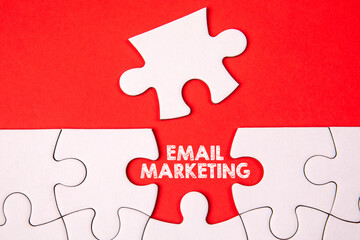 Fototapeta premium Email Marketing concept. White puzzle pieces on an red background