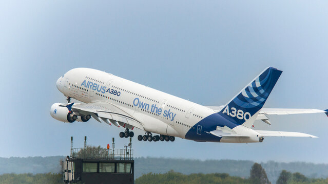 French passenger wide-body Airbus A-380 lands with landing gear extended and takes off from concrete runway. Close-up of wing mechanization in extended position. Zhukovsky, Russia - August 31, 2013