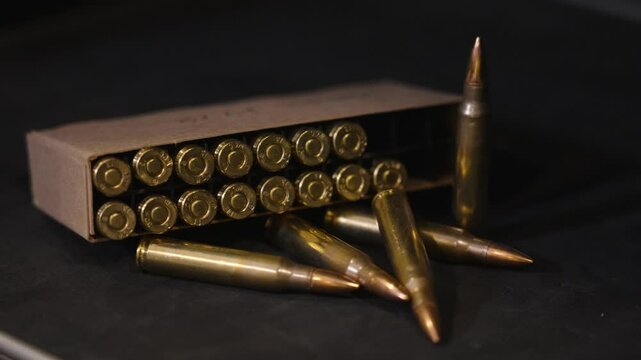 Panning right across box of ammo in 5.56 Nato.