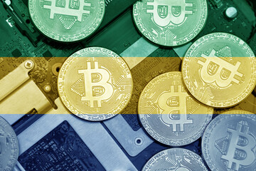 flag of gabon on the bitcoins with computer electronic circuit board background. bitcoin concept.